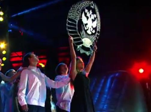 В видео-анонсе байк-шоу «Ковчег спасения» одна из участниц держит герб в виде царского орла в обрамлении венка из колосьев с ленточками союзных республик.